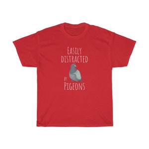 May include: Red t-shirt with white text that reads "Easily Distracted by Pigeons" and a cartoon image of a pigeon.
