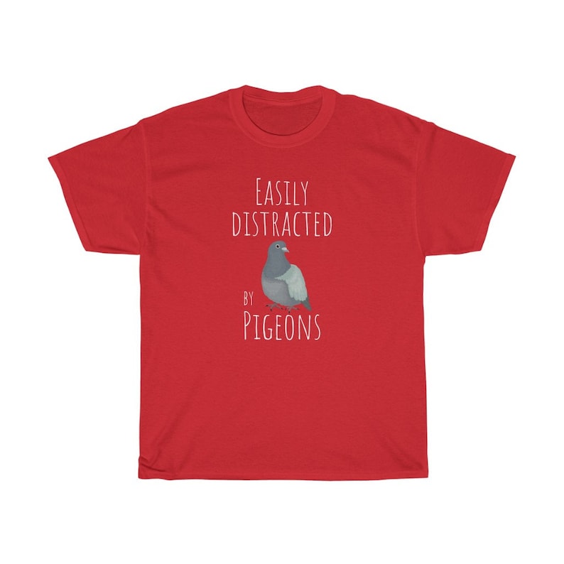 May include: Red t-shirt with white text that reads "Easily Distracted by Pigeons" and a cartoon image of a pigeon.