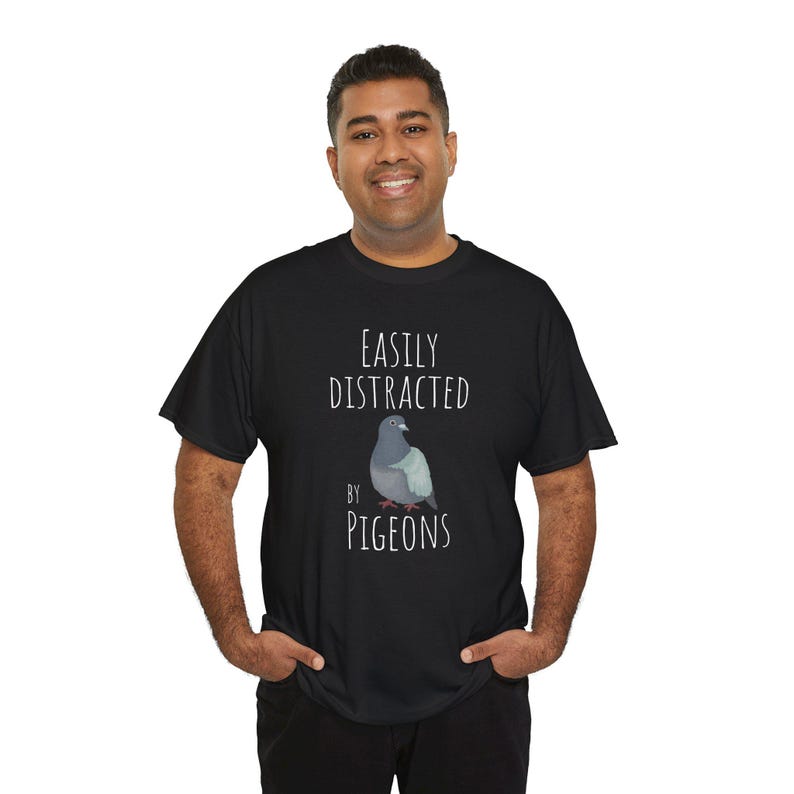 May include: A black t-shirt with the text "Easily Distracted by Pigeons" and a cartoon image of a pigeon.