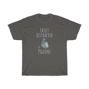 May include: A dark grey t-shirt with the text "EASILY DISTRACTED BY PIGEONS" and a cartoon image of a pigeon.