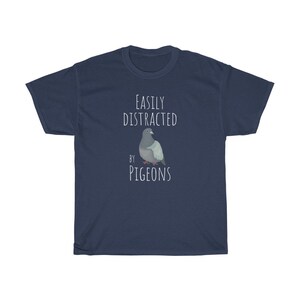 May include: A navy blue t-shirt with the text "Easily Distracted by Pigeons" and a cartoon image of a pigeon.