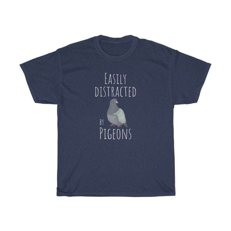 May include: A navy blue t-shirt with the text "Easily Distracted by Pigeons" and a cartoon image of a pigeon.