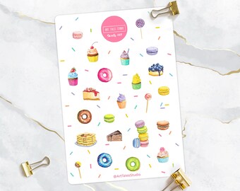 May include: A sheet of colorful stickers featuring various sweet treats, including cupcakes, donuts, macarons, and cake slices. The stickers are on a white background with a pink circle that says "Art Tales Studio" and "Sheet 008".