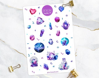 May include: A sheet of stickers featuring watercolor illustrations of crystals and gemstones in shades of purple, blue, and pink. The stickers are on a white background with a few small black and white geometric shapes. The text "Art Tales Studio" and "Crystals 039" are printed on the sheet.