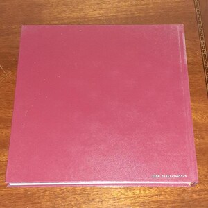 May include: A burgundy hardback book with a white spine and the text "ISBN 0-637-54043-9" printed on the bottom edge.