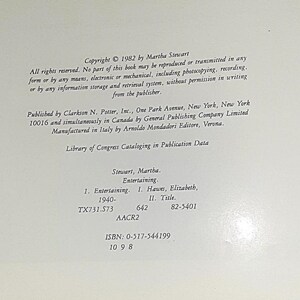 May include: Copyright information for a book titled "Entertaining" by Martha Stewart. The book was published in 1982 by Clarkson N. Potter, Inc. and General Publishing Company Limited. The ISBN is 0-517-544199.