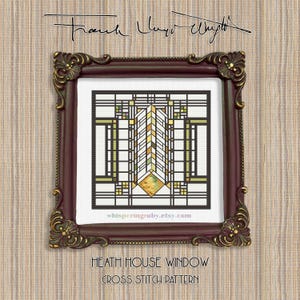 May include: A framed cross-stitch pattern of the Heath House Window design, featuring geometric shapes in black, white, and shades of yellow and green. The frame is ornate, dark brown with gold accents. The text "Frank Lloyd Wright" and "Heath House Window Cross Stitch Pattern" are visible.
