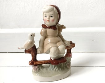 Porcelain figure, girl with bird, vintage