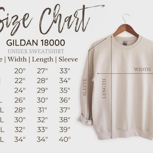 May include: A beige Gildan 18000 unisex sweatshirt hangs on a wooden hanger. The image includes a size chart with measurements in inches for width, length, and sleeve length, ranging from size S to 5XL.