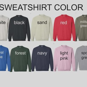 Puede incluir: Una exhibici&oacute;n de diez sudaderas de cuello redondo en varios colores, incluyendo blanco, negro, arena, rojo, verde militar, azul real, verde bosque, azul marino, rosa claro y gris deportivo. Cada sudadera tiene el nombre del color impreso.
