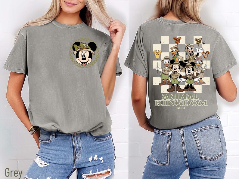 May include: Grey t-shirt with a Minnie Mouse design on the front and a Disney Animal Kingdom graphic on the back. The back design features Mickey Mouse, Donald Duck, and Goofy, with the text "ANIMAL KINGDOM EST. 1998".