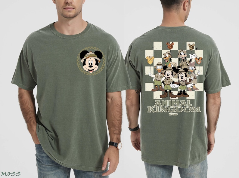 May include: Olive green t-shirt with a Mickey Mouse graphic wearing a safari hat on the front. The back features a checkered design with Disney characters in safari outfits, and the text "ANIMAL KINGDOM" and "EST. 1998".