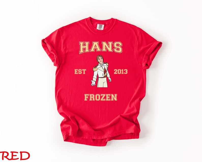 May include: A red t-shirt with the name "HANS" in gold lettering above an illustration of a character in a white and gold uniform. The text "EST 2013" and "FROZEN" are also printed on the shirt.