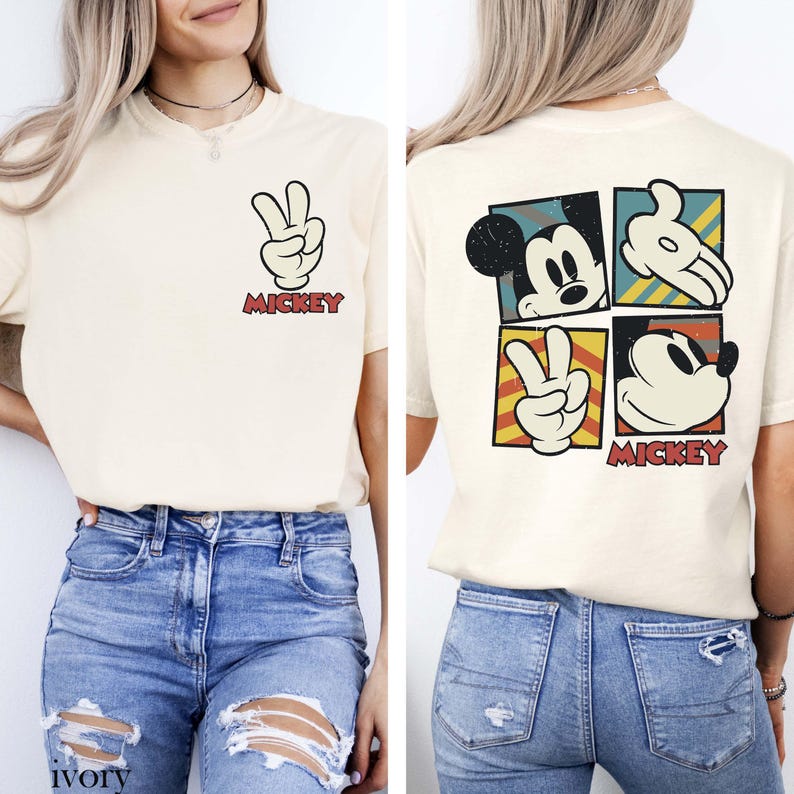May include: Ivory t-shirt with Mickey Mouse graphics. The front shows a peace sign made with Mickey's glove and the word "Mickey." The back has four Mickey Mouse images in squares. A casual, fun tee.