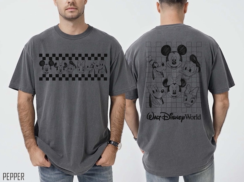 May include: A charcoal gray short-sleeve t-shirt featuring a black checkered band with Disney character faces on the front and a larger grid pattern with character faces and the text Walt Disney World on the back. The shirt is labeled as pepper color.
