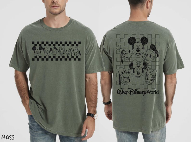 May include: An olive green short-sleeve t-shirt featuring a black graphic of Disney character faces on a checkered band on the front, and a larger grid graphic with character faces and the text Walt Disney World on the back.