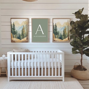 May include: Three framed prints with a watercolor mountain landscape design. The center print features the letter "A" and the name "Alexander" in white text on a sage green background.