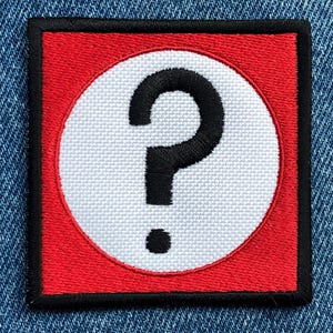 May include: A red square with a white circle containing a black question mark. The question mark has a dot below it.