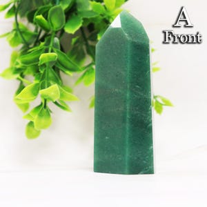 May include: A polished green crystal tower with a hexagonal base and a pointed top. The stone features a deep forest green color with subtle natural variations in texture. The text A Front is visible in the upper right corner of the image.