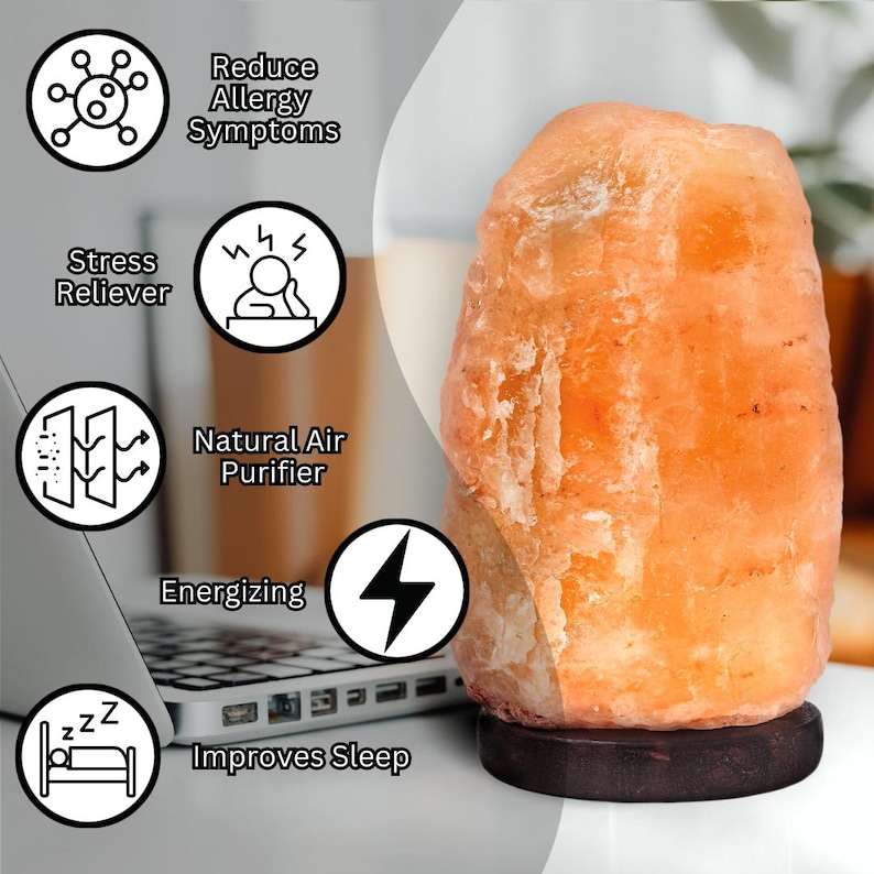 May include: A large, orange Himalayan salt lamp with a wooden base. The lamp is on a white surface and there are several icons around it that list the benefits of using a salt lamp, including reducing allergy symptoms, stress relief, natural air purification, energising, and improving sleep.