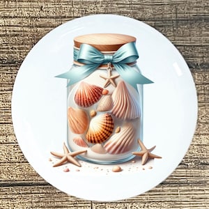 May include: A white ceramic plate featuring a jar filled with seashells. The jar has a wooden lid, a light blue ribbon, and a starfish charm. Several starfish and seashells are scattered around the jar.