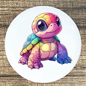 May include: A colorful cartoon turtle with a rainbow shell and big eyes. The turtle is depicted in shades of pink, yellow, blue, and green, with a friendly expression. The turtle is on a white background.