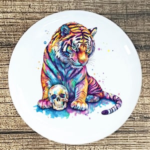 May include: A set of three ceramic mugs with a speckled, matte finish. The mugs are in shades of cream, light brown, and dark brown. Each mug has a simple, minimalist design, perfect for coffee or tea.