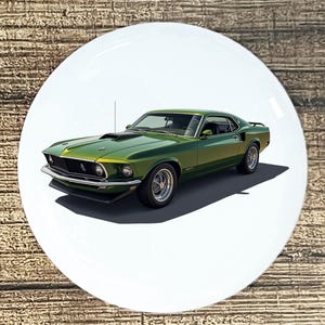 May include: A green classic car with chrome wheels and a black hood scoop is featured on a white circular background. The car is a vintage model, likely from the late 1960s or early 1970s, with a sleek, aerodynamic design.