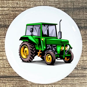 May include: A green tractor with a white cab and large wheels. The tractor is on a white background.
