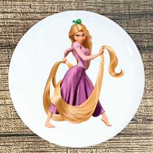 May include: A cartoon image of Rapunzel, a long-haired princess, holding her hair in her hands. She is wearing a purple dress and has a green chameleon on her head.