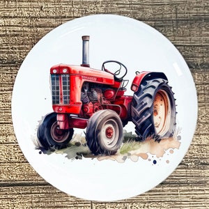 May include: A red and black vintage tractor with the word "COUGAR 15" on the side. The tractor is on a white background with watercolor splatters.