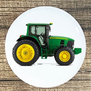 May include: A green John Deere 7530 tractor with large tires and a white background.