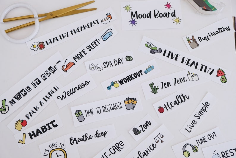 May include: A selection of white rectangular stickers with black text and colourful illustrations related to health and wellbeing. Phrases include "Healthy Breakfast," "More Sleep," "Workout," and "Live Healthy." Gold scissors are in the upper left.