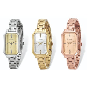 May include: Three women's watches with different colored bands. The watch on the left has a silver band, the middle watch has a gold band, and the watch on the right has a rose gold band. All three watches have a rectangular face with a CHISEL logo and diamond accents.