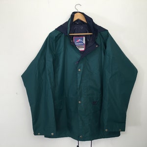 May include: A dark green hooded jacket with a navy blue lining and a white label with the text "Helly Hansen" on the front.