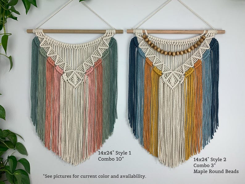 Pode incluir: Dois pain&eacute;is de macram&eacute; suspensos em varas de madeira. A pe&ccedil;a da esquerda apresenta cord&otilde;es de algod&atilde;o em verde s&aacute;lvia, rosa seco e creme. A pe&ccedil;a da direita inclui cord&otilde;es azul-marinho, amarelo mostarda e creme com contas de madeira de &aacute;cer.