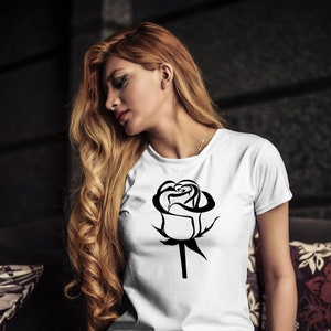 May include: A white t-shirt with a black stylized rose graphic.