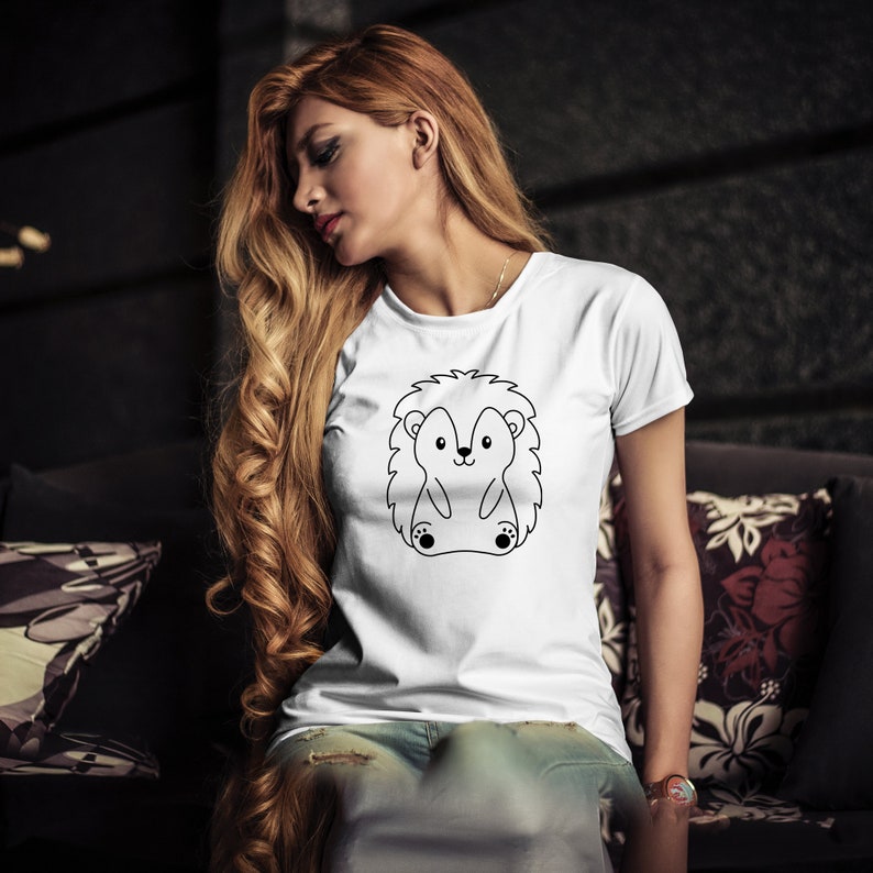May include: White t-shirt with a black line drawing of a hedgehog on the front.
