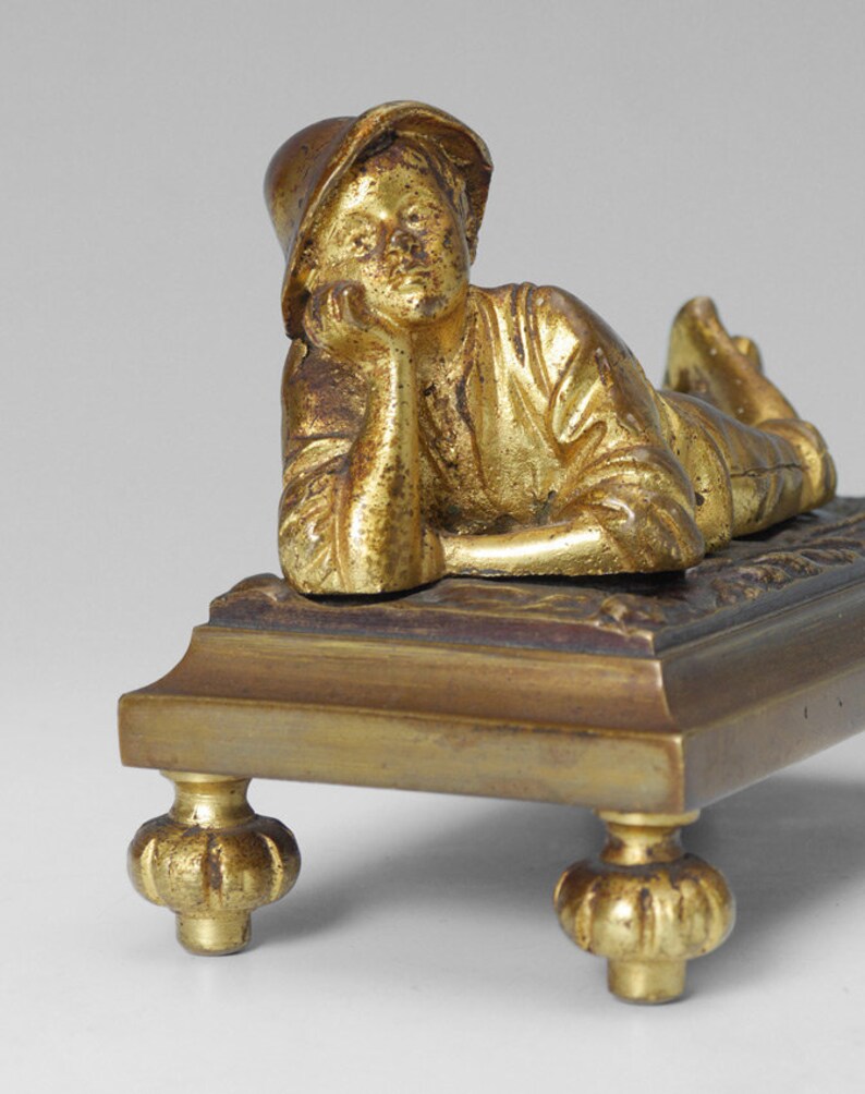 Small late 19th century bronze of reclining boy image 0