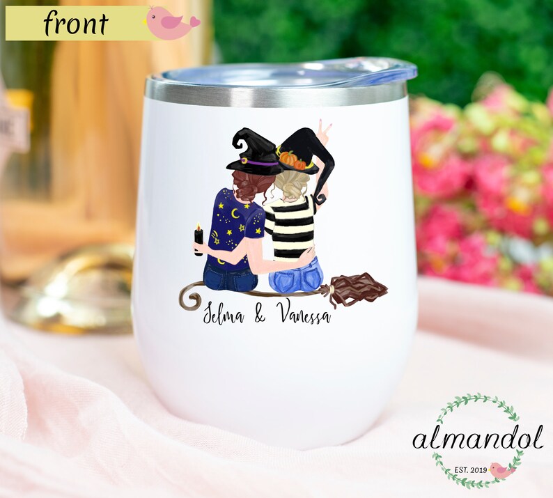 May include: White stainless steel wine tumbler with a graphic of two witches wearing black hats and holding a broom. The text "Selma & Vanessa" is printed below the graphic.