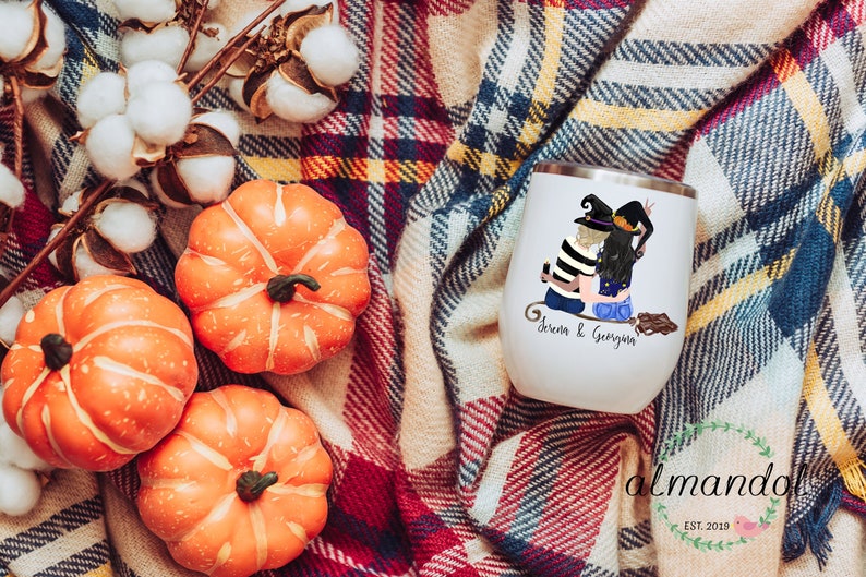 May include: White stainless steel wine tumbler with a black and white illustration of two witches sitting on a broomstick. The text "Serena & Georgina" is printed on the tumbler.