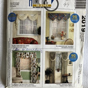 May include: A vintage McCall's Home Decor sewing pattern envelope. The front features four window treatment designs: a swag, a handkerchief valance, imperial valance with drapes, and easy swagged panels. The envelope includes text and illustrations.