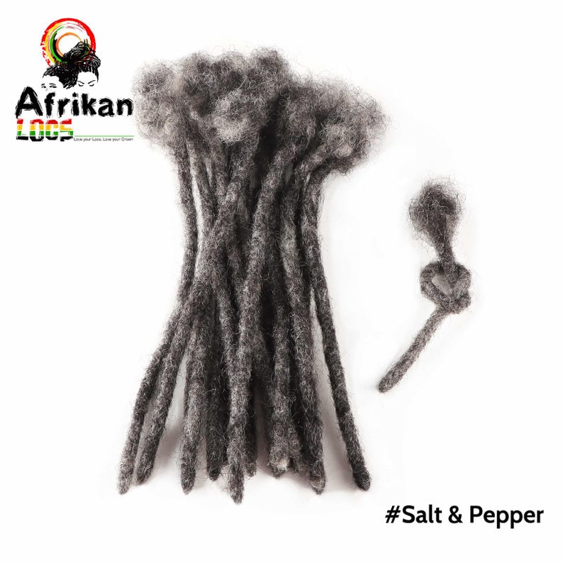 May include: A bundle of salt and pepper colored dreadlocks, with a single, knotted dreadlock to the right. The image includes the text "Afrikan Loox" and "#Salt & Pepper" on a white background. The dreadlocks are a dark gray color.