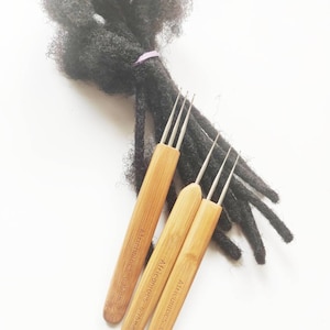 May include: Three wooden crochet hooks with metal tips for dreadlocks. The hooks are labelled "Africanhoops" and have measurements of 0.25mm, 0.20mm, and 0.75mm.
