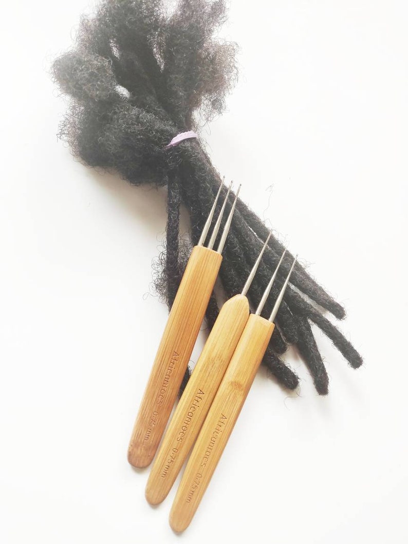May include: Three wooden crochet hooks with metal tips for dreadlocks. The hooks are labelled "Africanhoops" and have measurements of 0.25mm, 0.20mm, and 0.75mm.