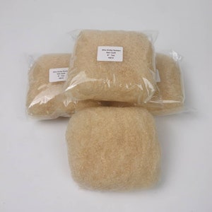 May include: Three packs of Afro kinky human hair bulk, each containing a light brown, fluffy, textured hair bundle. The label on the front pack reads "Afro kinky human hair bulk 8" - 1oz #013".