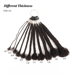 May include: A collection of black dreadlock extensions of varying thicknesses, ranging from 0.1 cm to 2.0 cm, attached to a metal ring. The text "Different Thickness" and "Unit: cm" are displayed.