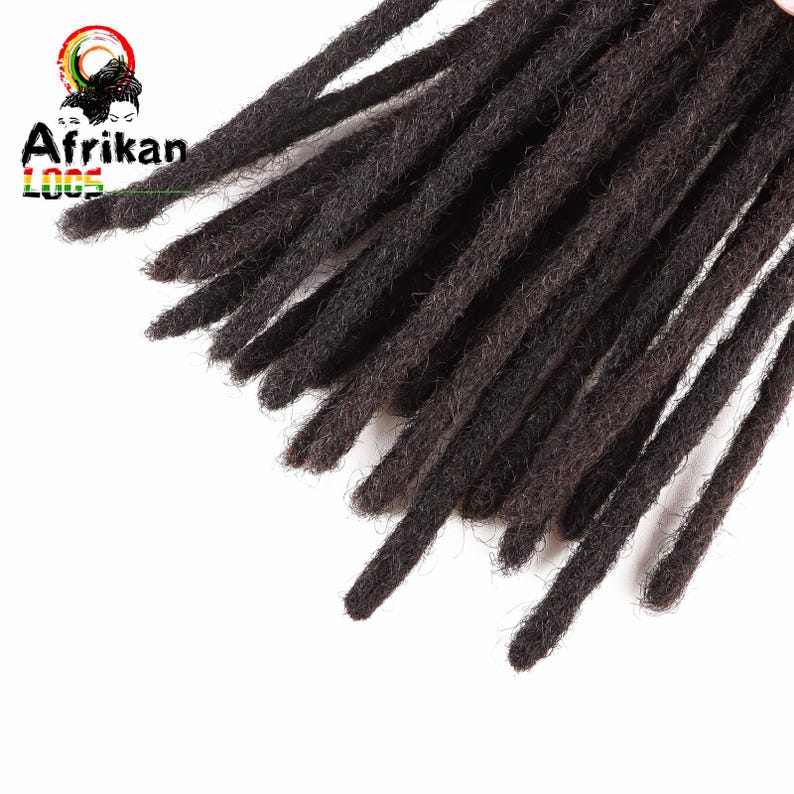 May include: Close-up of dark brown dreadlocks, arranged diagonally across a white background. The dreadlocks are thick and textured, with a natural, unkempt appearance. The logo "Afrikan Locs" is visible in the upper left corner.