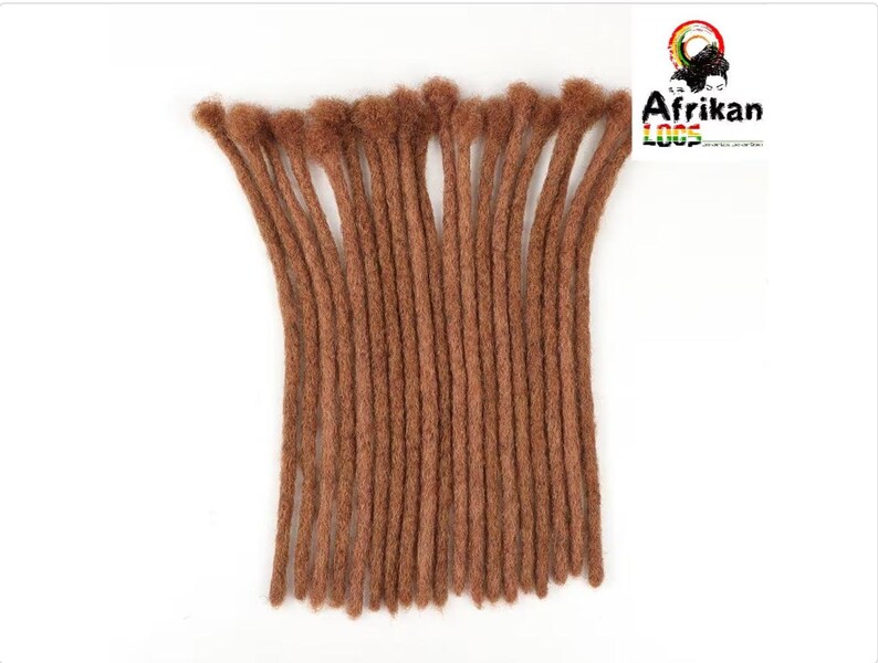 May include: A bundle of brown dreadlocks, arranged vertically against a white background. The dreadlocks are a warm, medium brown color and appear to be made of a textured material. The logo "Afrikan Loops" is visible in the upper right corner.