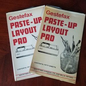 May include: Two white paper pads with red text that reads "Gestefax Paste-Up Layout Pad". The pad on the left has a black and white illustration of a Gestetner machine. The pad on the right has a black and white illustration of a jar of art supplies.
